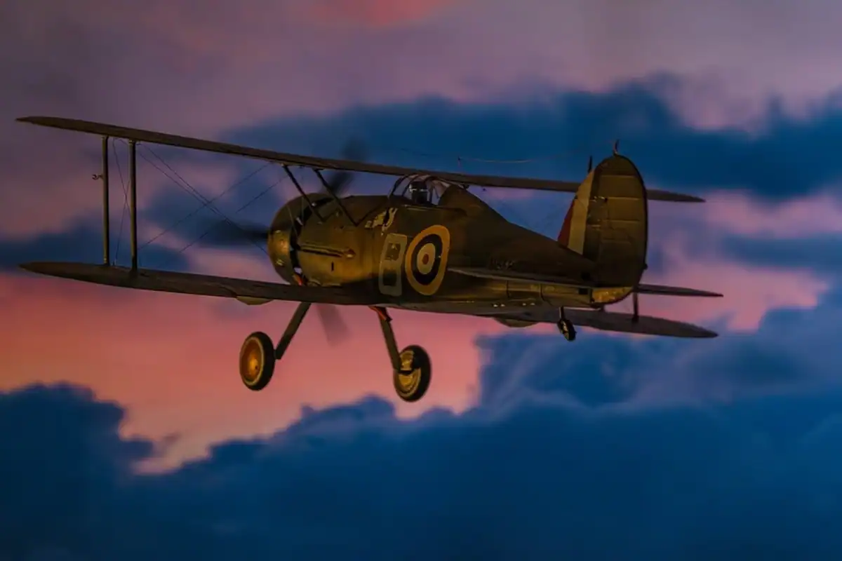 Model în miniatură, construit ca hobby, al unui avion istoric, în fața unui cer cu nori