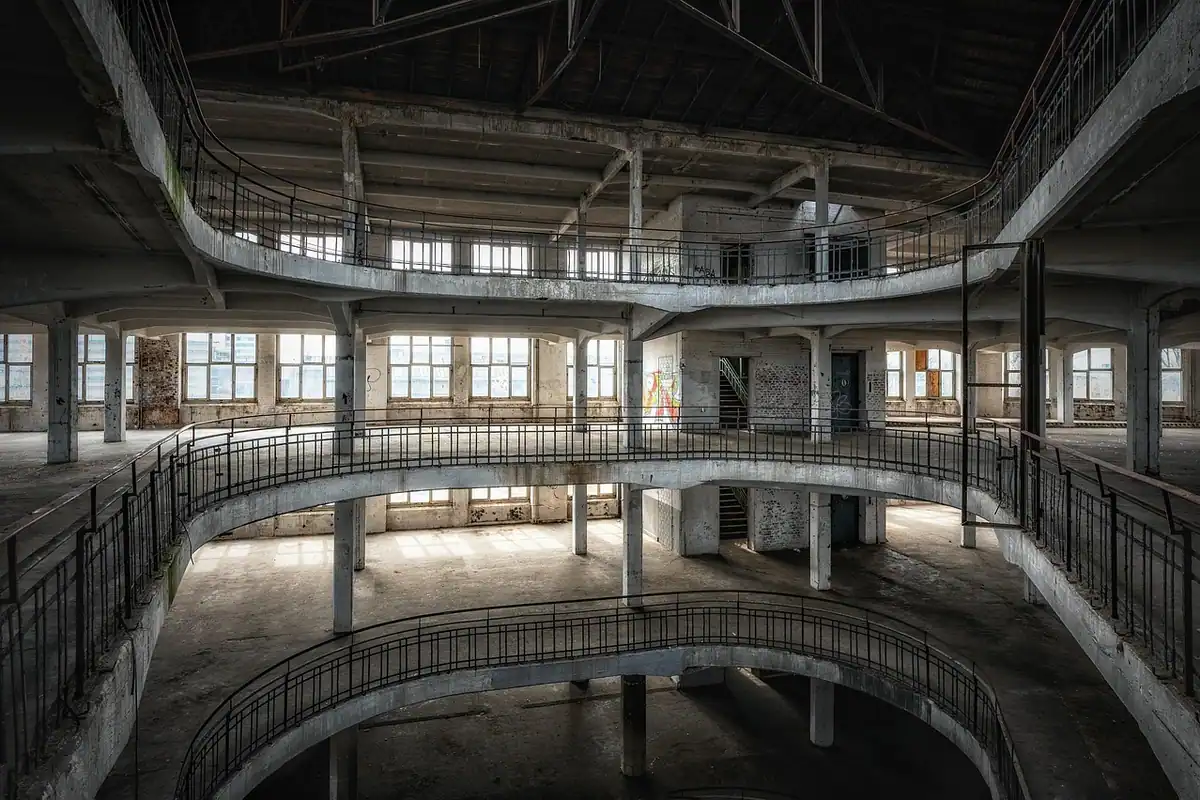 Interior gol dintr-o clădire abandonată, cu mai multe etaje și spații goale