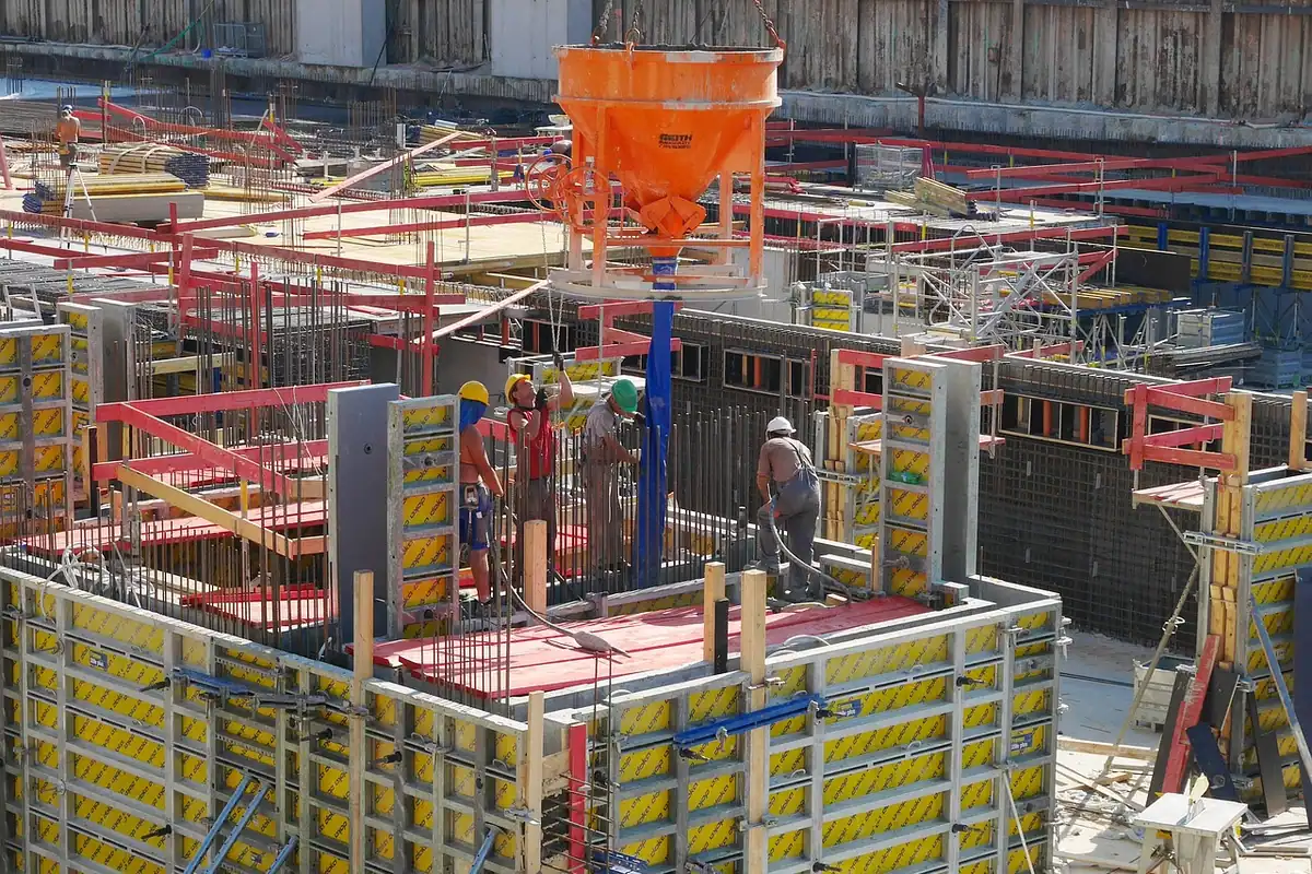 Cofraje galbene și roșii pe o fundație, cu o cupă de beton portocalie